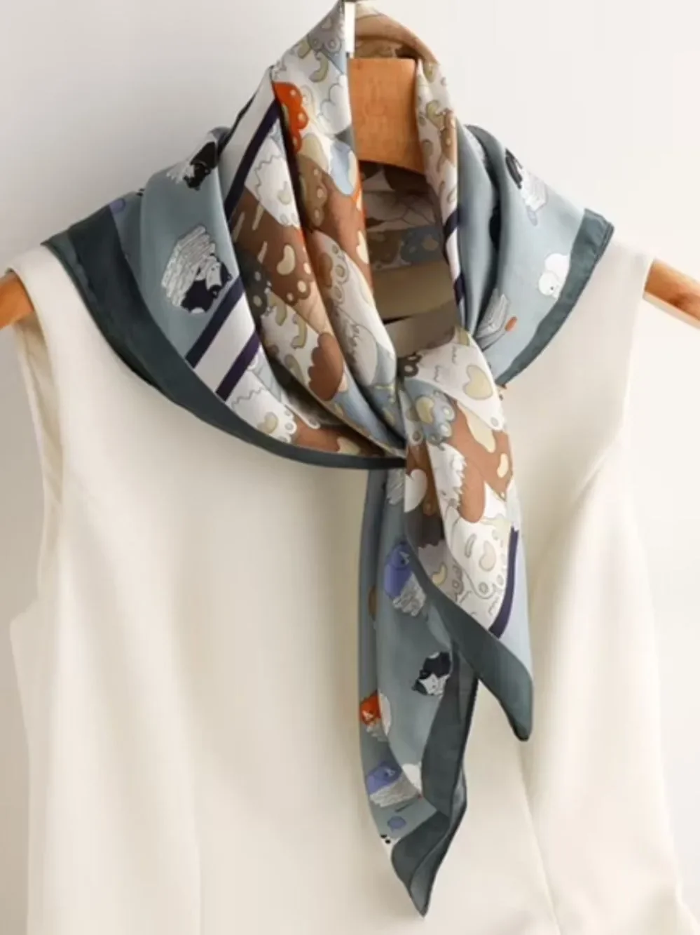 Playful Cat Paw Scarf in Orange & Navy feels like silk is polyester